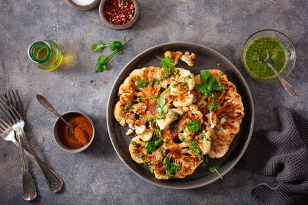 cauliflower steaks with herb sauce and spice. plant based meat substituteの写真素材