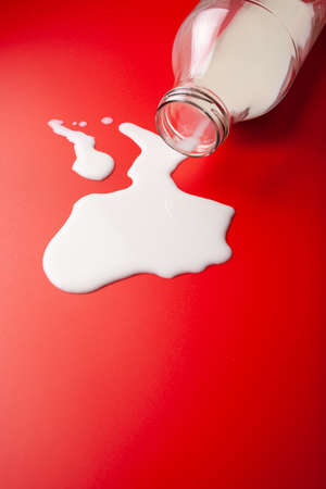 bad milk lactose intolerance allergy. milk bottle splatter. avoid dangerous dairyの写真素材