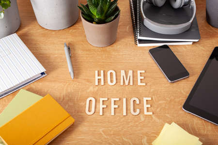 home office text desk with tablet computer smartphone notebook houseplants, working space at homeの写真素材