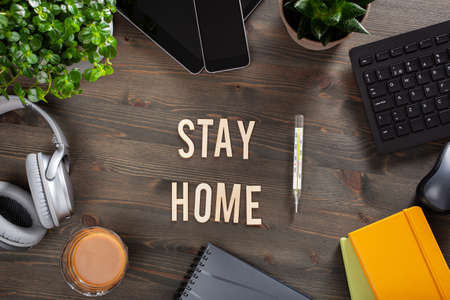 stay home text desk with keyboard computer smartphone notebook houseplants, workspace at homeの写真素材