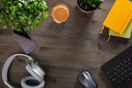 home office desk with keyboard computer smartphone notebook houseplants, workspace at home