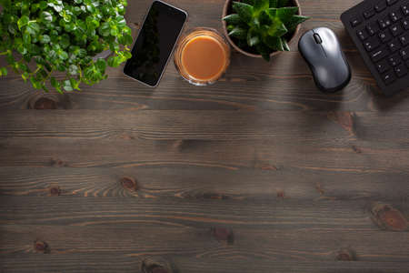 home office desk with keyboard computer smartphone notebook houseplants, workspace at home