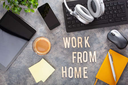 work from home text desk with keyboard computer smartphone notebook houseplants, workspace office at homeの写真素材