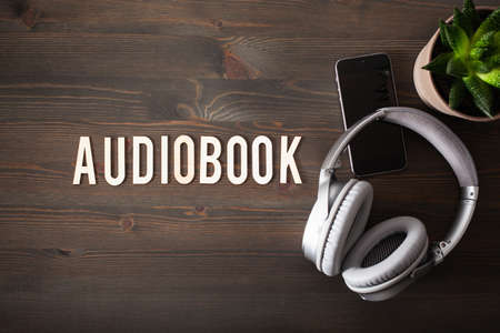 audiobook word text concept modern wireless headphones smartphoneの写真素材