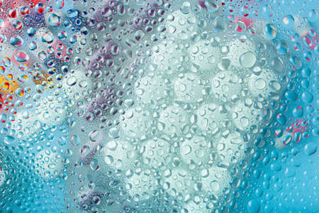 Pills through water drops on blueの写真素材