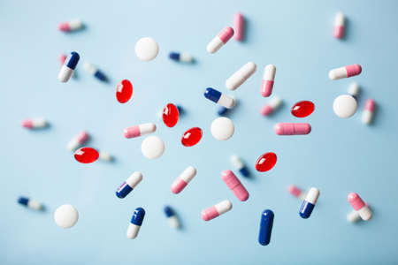 Flying pills on blueの写真素材
