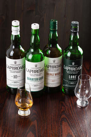 Trondheim, Norway - Mai 18 2020: Laphroaig single malt scotch whisky 10 years, quarter cask, lore, triple wood bottle and glassのeditorial素材