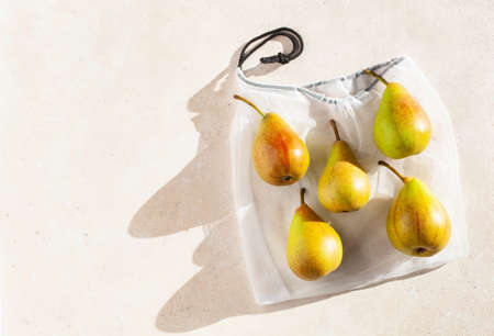 pears fruits in reusable mesh nylon bag, plastic free zero waste concept