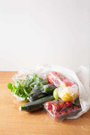 single use plastic waste issue. fruits and vegetables in plastic bagsの写真素材