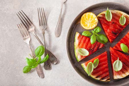 grilled watermelon slices with lemon and basil. summer dessert