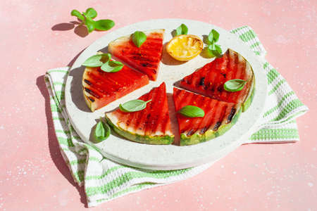 grilled watermelon slices with lemon and basil. summer dessertの写真素材