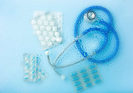 pill tablet capsule medicine stethoscope through water drops background