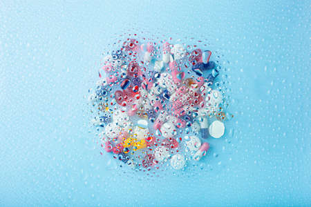 pill tablet capsule medicine through water drops background