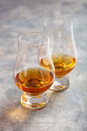 glass of whisky spirit brandy on gray concrete backgroundの写真素材