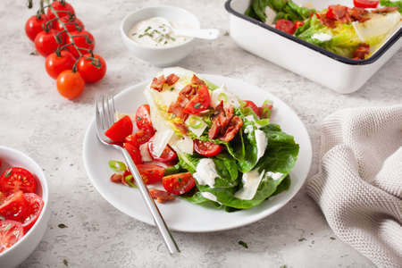 romaine lettuce topped with bacon tomato parmesan, sauce. healthy keto paleo diet lunchの写真素材