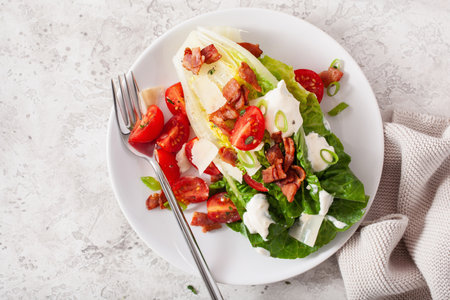 romaine lettuce topped with bacon tomato parmesan, sauce. healthy keto paleo diet lunchの写真素材