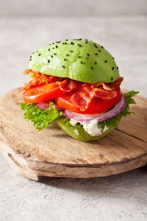 keto paleo diet avocado burger with bacon, lettuce, tomatoの写真素材