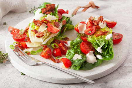 romaine lettuce topped with bacon tomato parmesan, sauce. healthy keto paleo diet lunchの写真素材