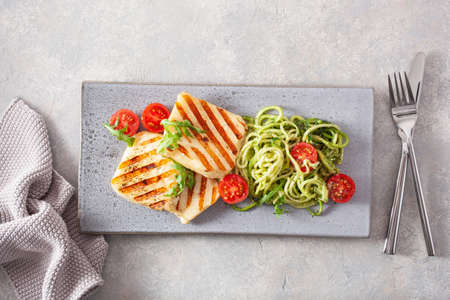 ketogenic paleo diet lunch. halloumi cheese, spiralized zucchini with arugula pesto and tomatoesの写真素材