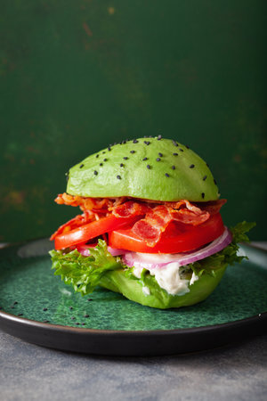 keto paleo diet avocado burger with bacon, lettuce, tomatoの写真素材