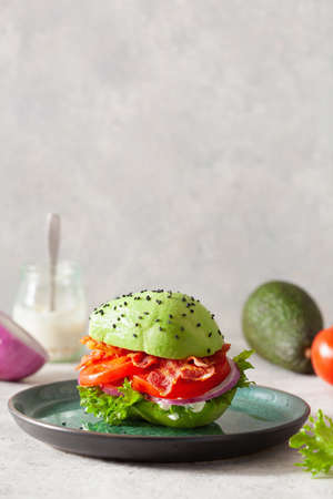 keto paleo diet avocado burger with bacon, lettuce, tomatoの写真素材