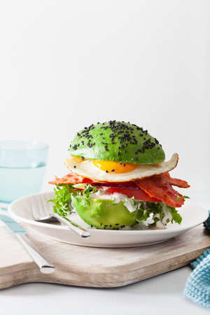 keto paleo diet avocado breakfast burger with bacon, egg, tomatoの写真素材