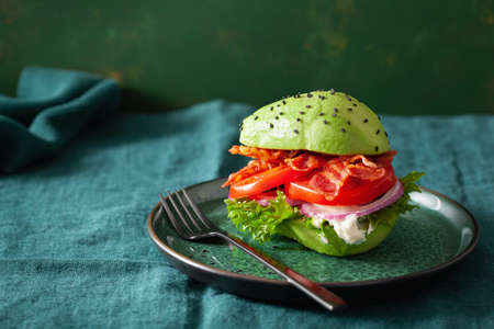 keto paleo diet avocado burger with bacon, lettuce, tomatoの写真素材