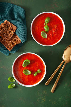 tomato and bell pepper vegetarian soup on green backgroundの写真素材