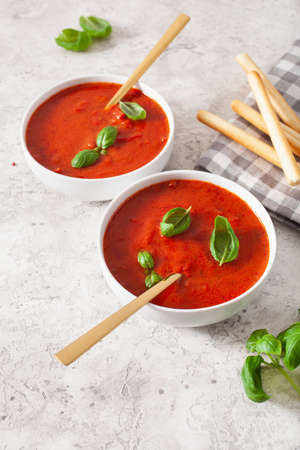 tomato and bell pepper vegetarian soup on green backgroundの写真素材