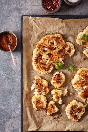 cauliflower steaks with herb and spice on baking tray. plant based meat substituteの写真素材