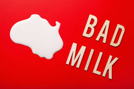 bad milk word letter text lactose intolerance allergy. milk splatter. avoid dangerous dairyの写真素材