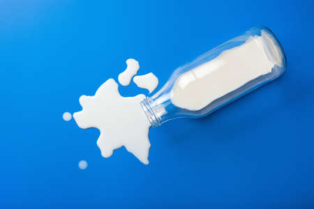 bad milk lactose intolerance allergy. milk bottle splatter. avoid dangerous dairyの写真素材