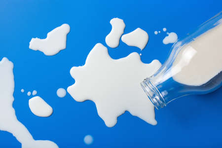bad milk lactose intolerance allergy. milk bottle splatter. avoid dangerous dairyの写真素材