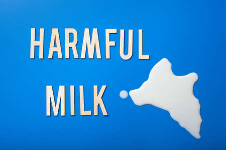 harmful milk word text letters lactose intolerance allergy. milk splatter. avoid dangerous dairyの写真素材