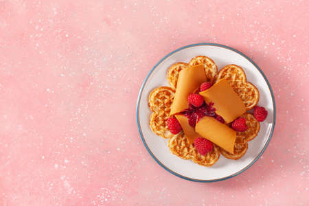 waffles with Norwegian brunost traditional brown cheese and raspberry jamの写真素材