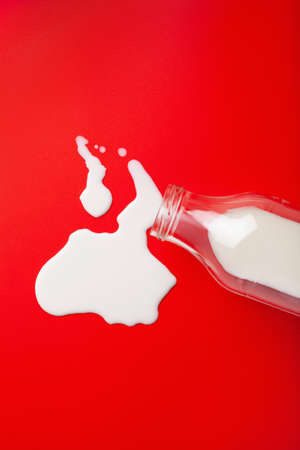 bad milk lactose intolerance allergy. milk bottle splatter. avoid dangerous dairyの写真素材
