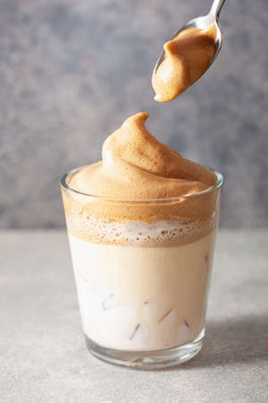 dalgona coffee in glass. trendy Instant coffee whipped with sugar and hot waterの写真素材
