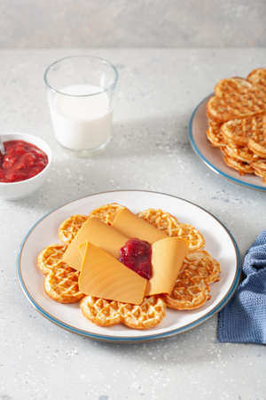 waffles with Norwegian brunost traditional brown cheese and raspberry jamの写真素材