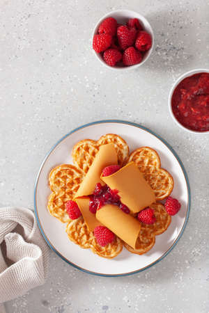 waffles with Norwegian brunost traditional brown cheese and raspberry jamの写真素材