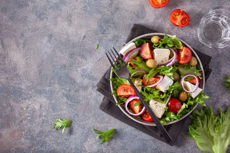 tomato salad with brie cheese olives onion lettuceの写真素材