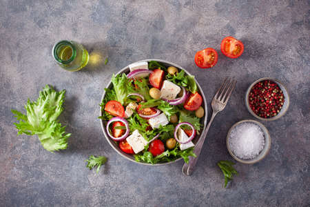 tomato salad with brie cheese olives onion lettuceの写真素材