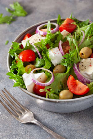 tomato salad with brie cheese olives onion lettuceの写真素材