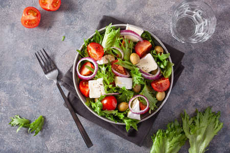 tomato salad with brie cheese olives onion lettuceの写真素材