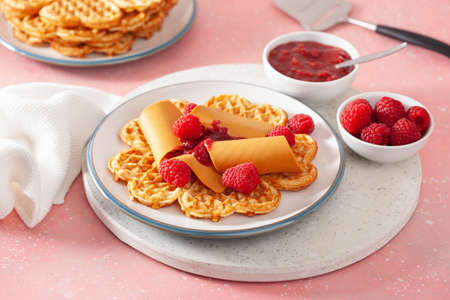 waffles with Norwegian brunost traditional brown cheese and raspberry jamの写真素材