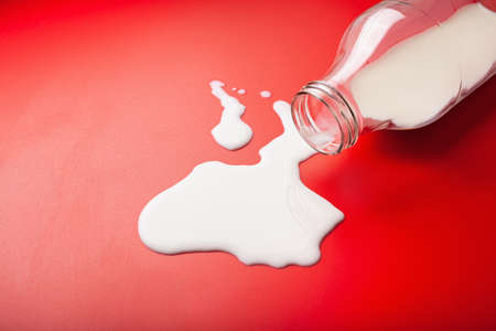 bad milk lactose intolerance allergy. milk bottle splatter. avoid dangerous dairyの写真素材