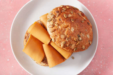 fresh bun with Norwegian brunost traditional brown cheeseの写真素材