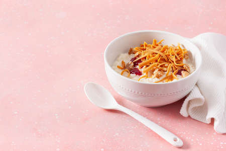 rice pudding with Norwegian brunost traditional brown cheese and raspberry jamの写真素材