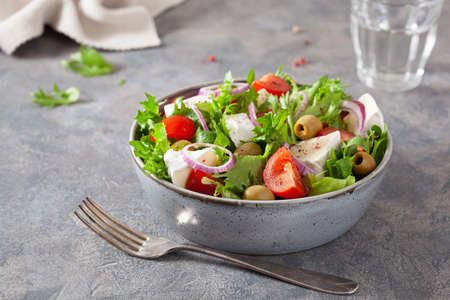 tomato salad with brie cheese olives onion lettuceの写真素材