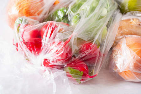 single use plastic waste issue. fruits and vegetables in plastic bagsの写真素材