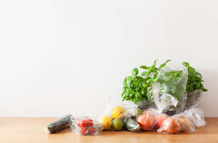 single use plastic waste issue. fruits and vegetables in plastic bagsの写真素材